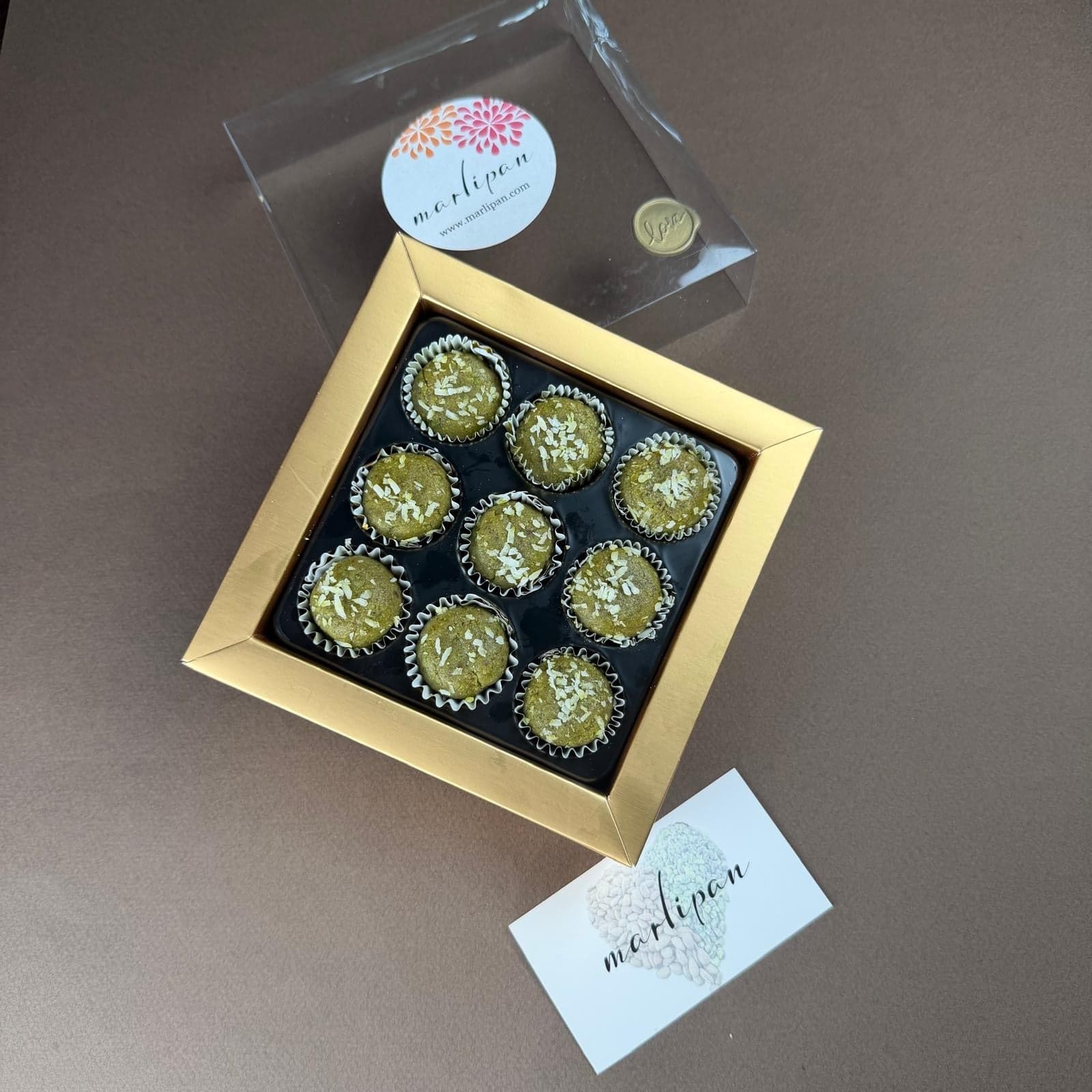 Esmeralda pistachio marzipan pieces dusted with shredded coconut